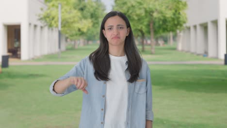 upset indian girl showing thumbs down