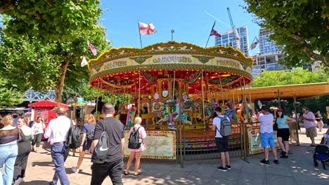 people enjoying a carousel ride in london