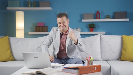 Home-office-worker-man-experiencing-joy-looking-at-camera.