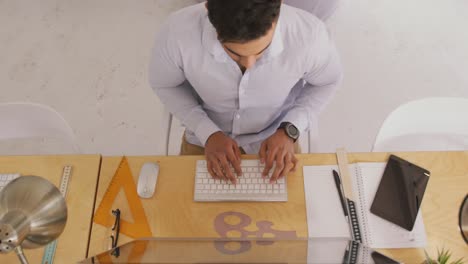 View-from-above-of-man-working-in-creative-office