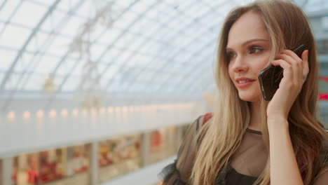 young attractive girl goes shopping in mall, talking on phone, shopping concept, fashion concept, communication concept