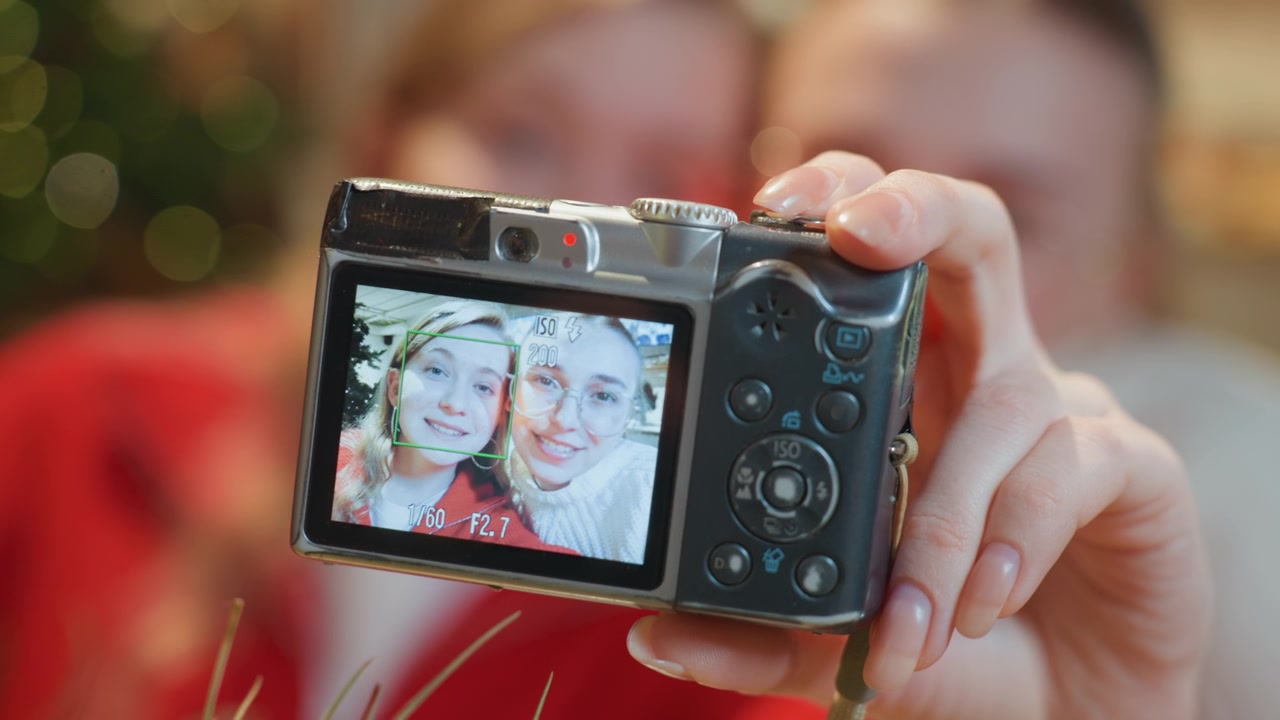 Happy Young Women Taking a Selfie with a Digital Camera