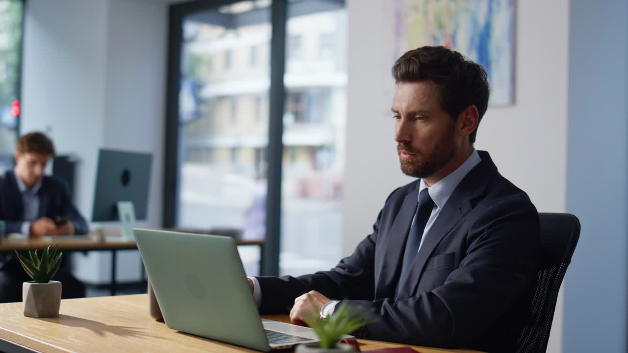 Focused manager looking computer screen workplace closeup. Man making coffee sip