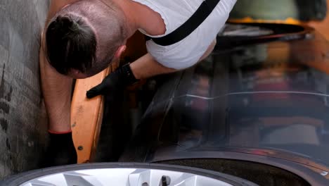 man working on car during maintenance