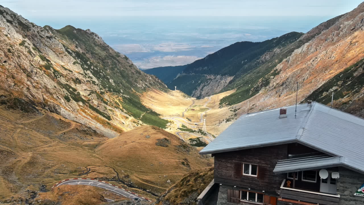 Scenic Mountain Valley with Road and Building