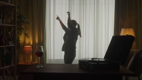 Woman Dancing at Home with a Glass of Wine