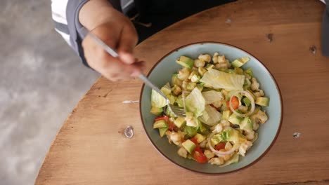 woman eating shrimp avocado salad