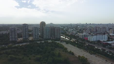 50-FPS-up-down-tilt-movement-shot-from-a-drone-over-city-panorama-at-sunset