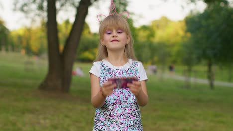 Children-girl-loses-on-mobile-phone-game,-use-squishy-silicone-anti-stress-pop-it-toy-to-calm-down