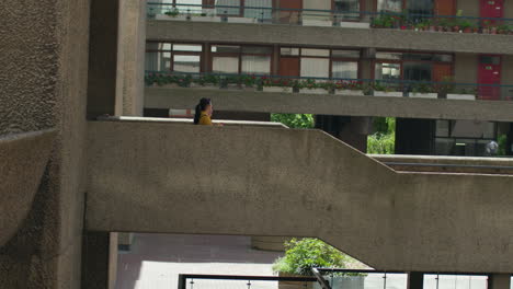 Two-Young-Female-Friends-Walking-Through-The-Barbican-Centre-In-City-Of-London-Together-1