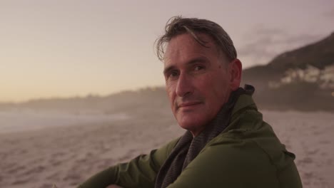 active senior sitting on beach