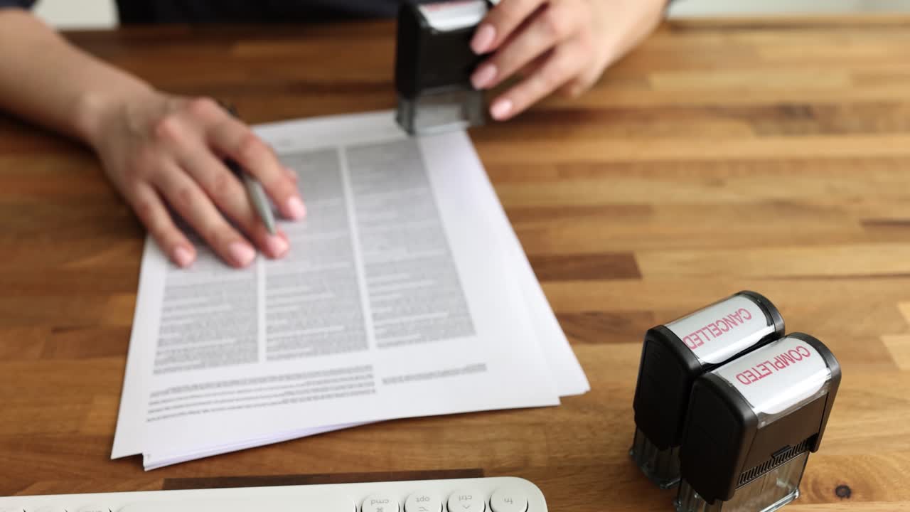 Person processing documents with rubber stamps