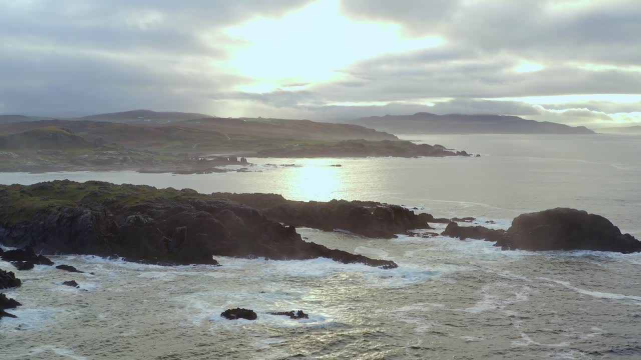 Sweeping aerial pan of Malin Head, Ireland's northernmost point, in morning fog