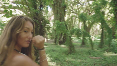 arc shot of natural blonde girl, tanned natural beauty in exotic jungle