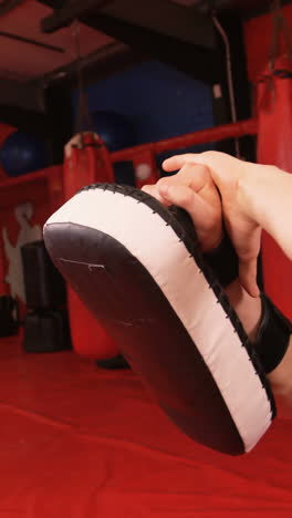 female boxer practicing with trainer