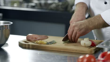 Chef-hands-cutting-greenery-at-kitchen.-Closeup-of-chef-hands-cutting-vegetables