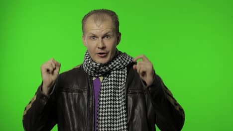 Handsome-positive-rocker-man-in-brown-denim-jacket-pointing-finger-at-camera.-Chroma-key