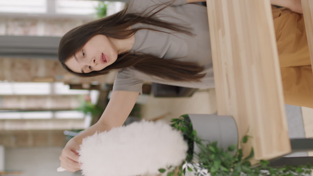 Vertical Shot of Happy Woman Dusting and Dancing