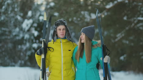 man and woman in love with ski equipment going to ski terrain