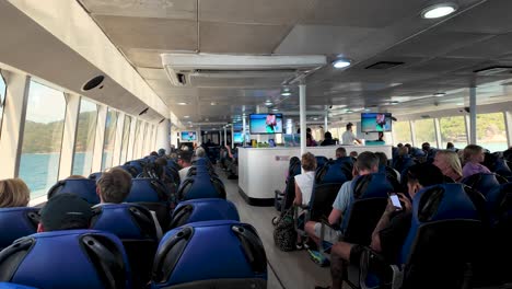 interior view of a crowded passenger ferry in thailand, showcasing travelers enjoying a scenic ride.