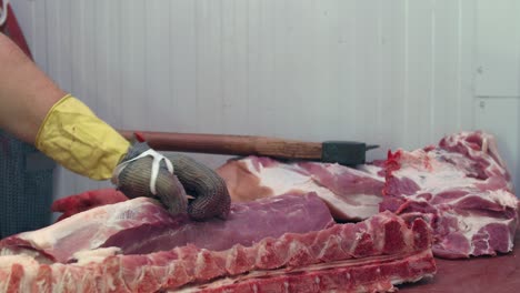 butcher separates the meat from the spine with a sharp knife