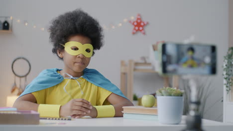 child superhero in video call