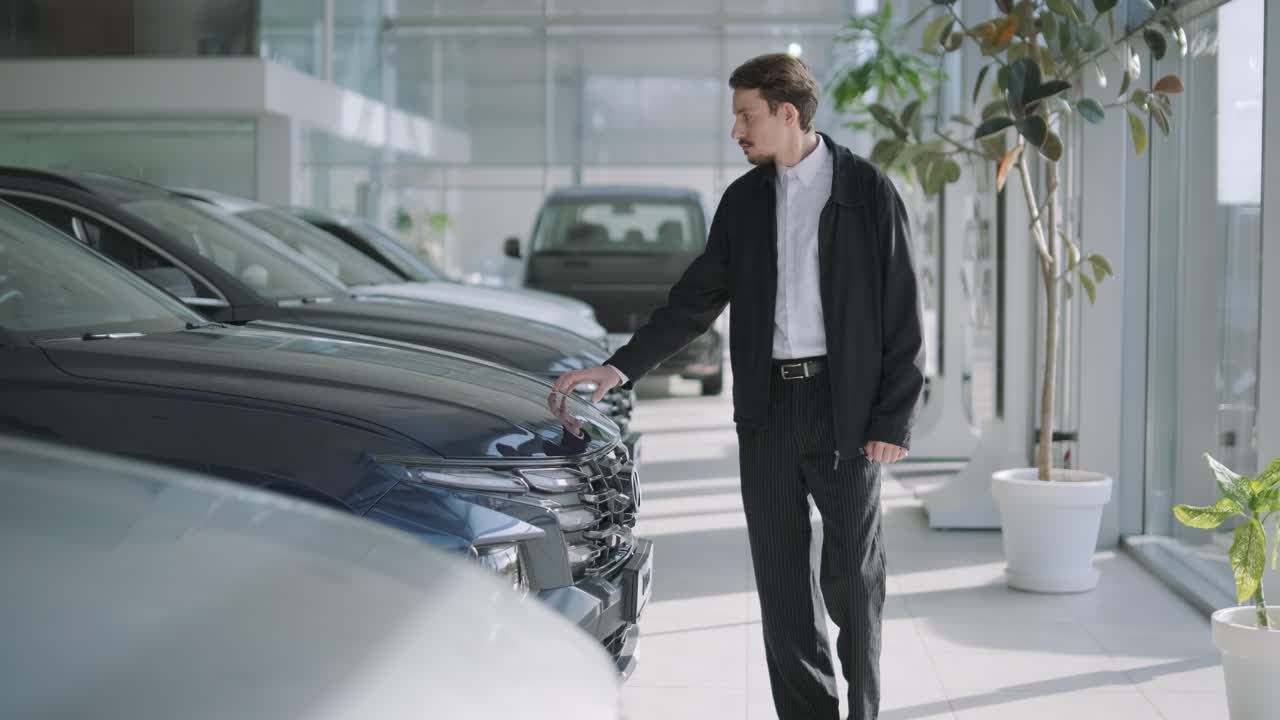 hombre mirando coches en un concesionario