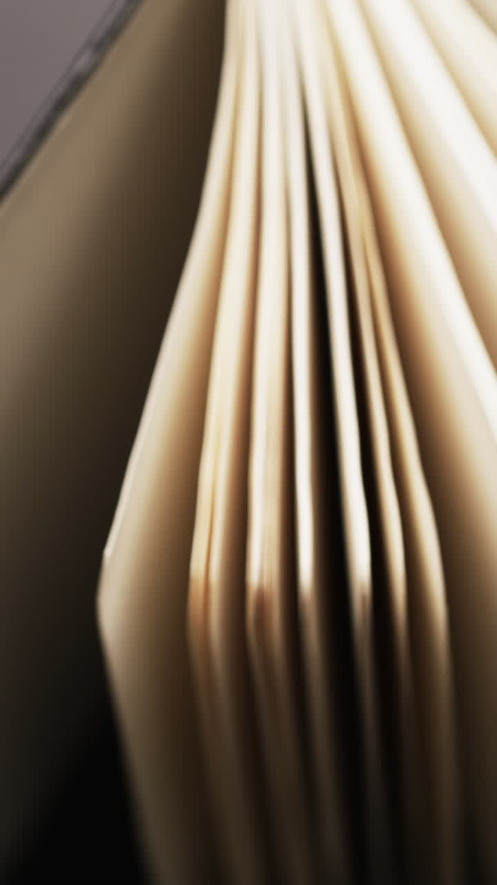 Vertical video of micro of book pages and copy space on grey background