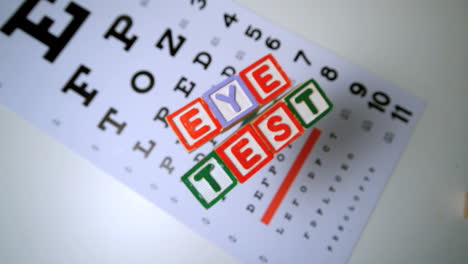 blocks spelling out eye test falling onto eye test