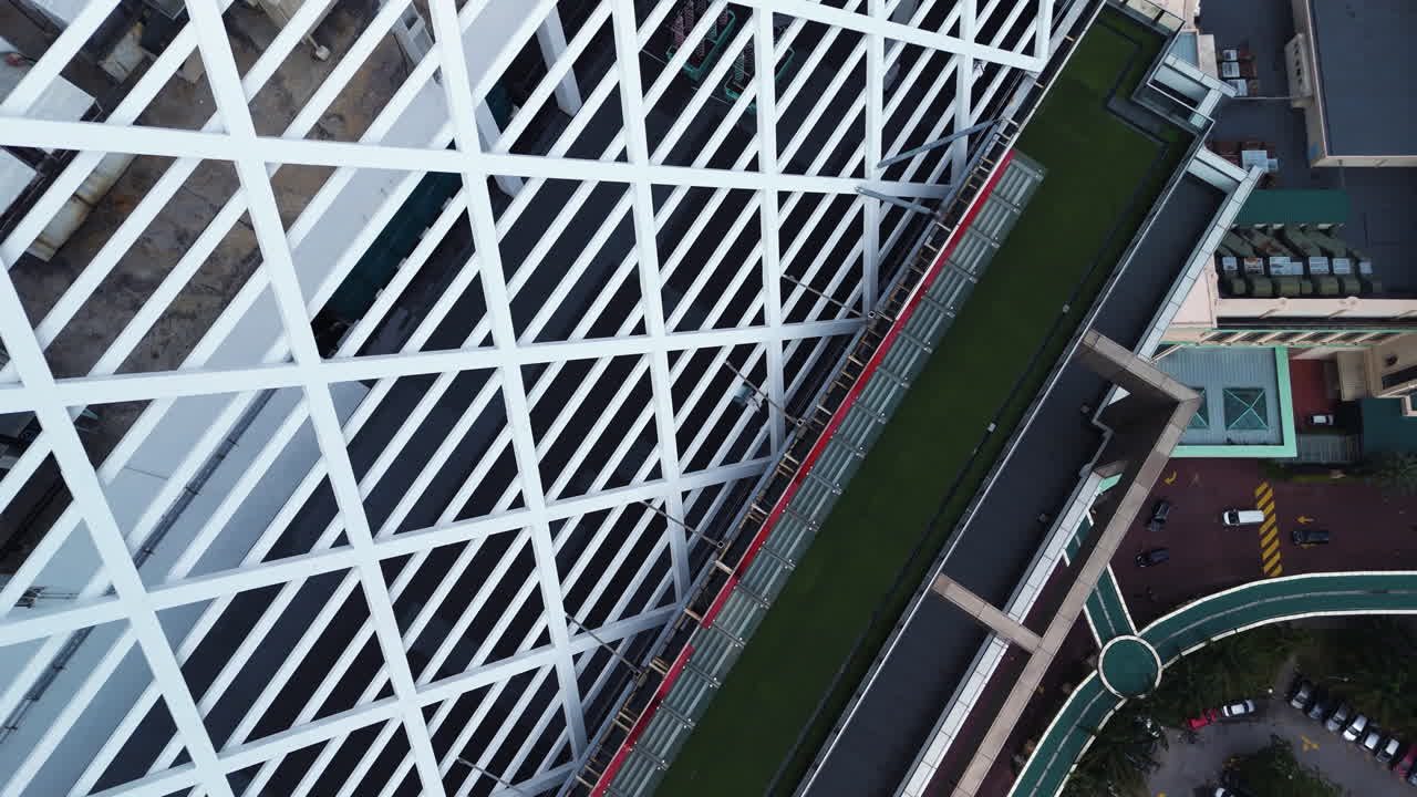 Drone diving around the Sunway tower building in cloudy Kuala Lumpur, Malaysia