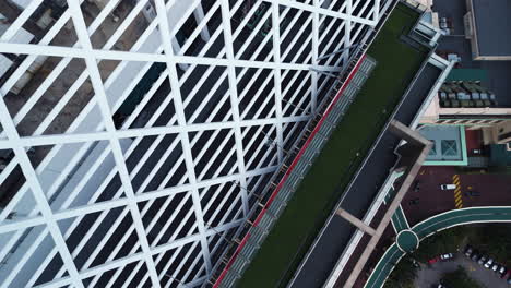 drone diving around the sunway tower building in cloudy kuala lumpur, malaysia