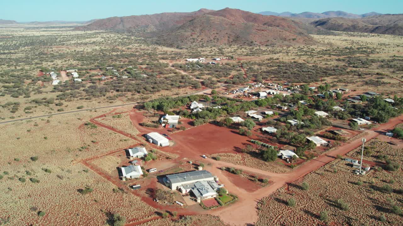 Sideways aerial view of the town of Umuwa and surrounding landscape, South Australia, Australia. August 2022.