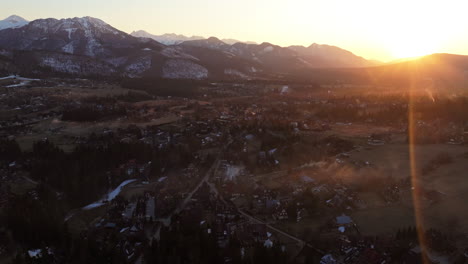 establishing drone shot of beautiful fire sky sunrise over tatra mountains and zakopane in podhale region, poland