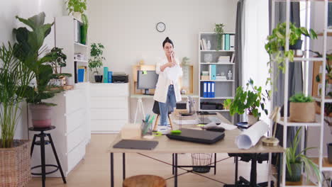 Businesswoman-Takes-Invoice-from-Printer-and-Sits-at-Desk