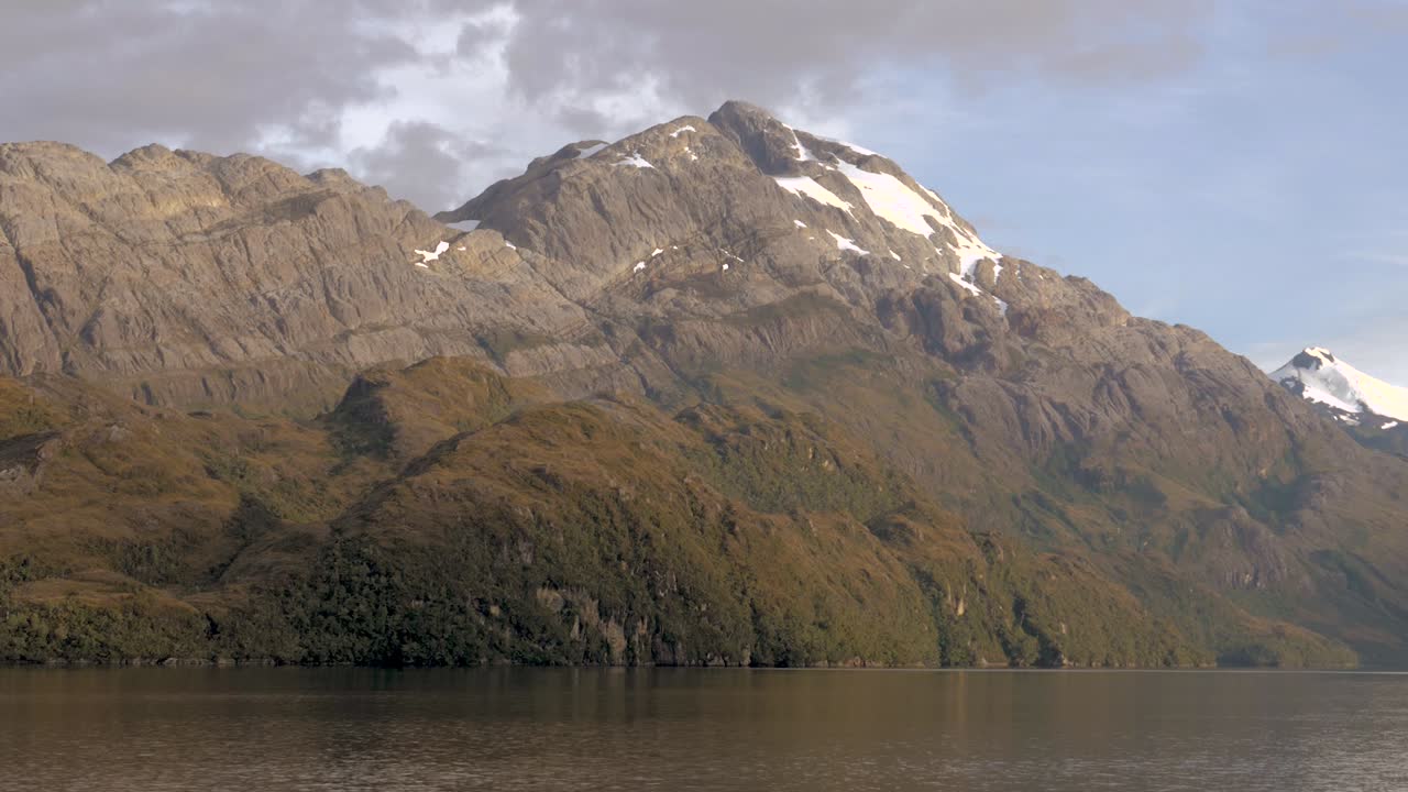 Patagonia. In the islands of Chile, a beautiful mountain on a fjord with some snow