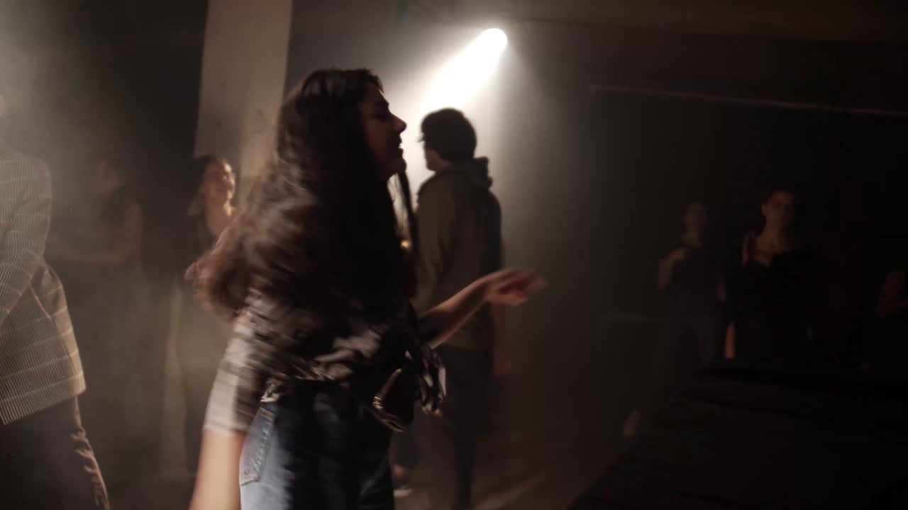 Energetic Woman Dancing And Grooving On The Dance Floor In The Club In Kyiv, Ukraine At Night. medium shot