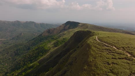 drone flies above countryside mountains landscape in panama, el valle de anton crater