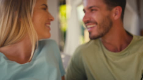 Close-Up-Of-Couple-With-Pregnant-Woman-In-Bedroom-At-Home-With-Man-Feeling-Baby's-Heartbeat