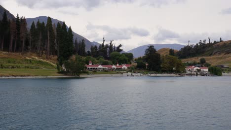 wide shot arriving to walter peak farm from tss earnslaw, lake wakatipu, queenstown, new zealand