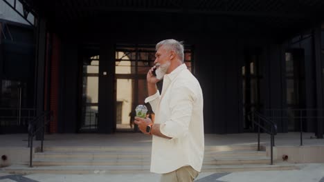 elderly man talking on phone while walking