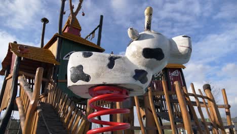 close up shot of moving animal swing on empty playground during sunny day