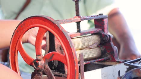 hands operating a traditional spinning wheel