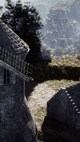 stone tower and windmill in a medieval landscape