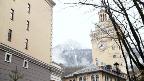 snowy mountains and city streets in a european town on a rainy day