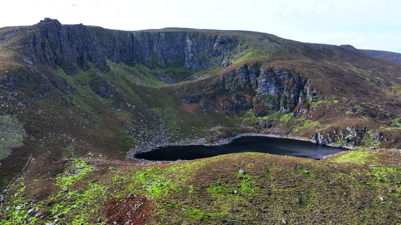 Epic Mountain Landscapes Ireland drone panning left under Crottys Rock and lake wild places in The Comeragh Mountains Waterford