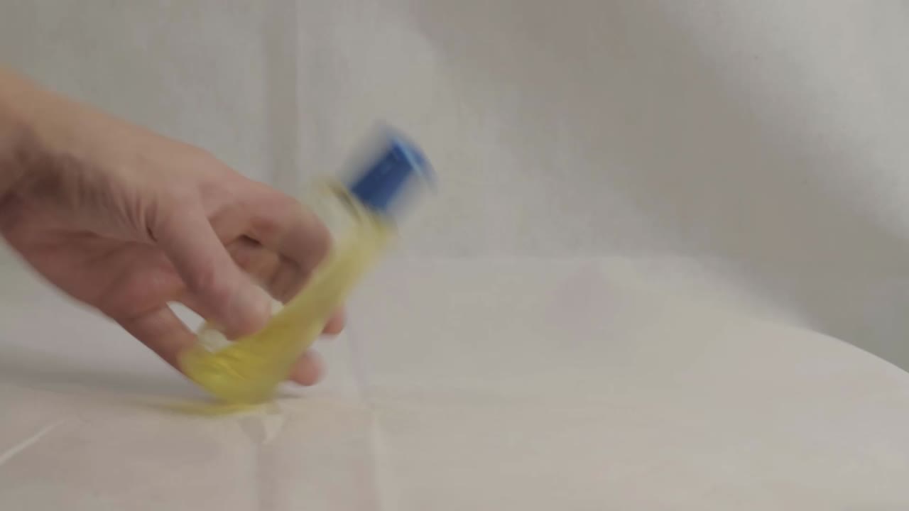 Hands using bottle of sanitizer gel wide shot