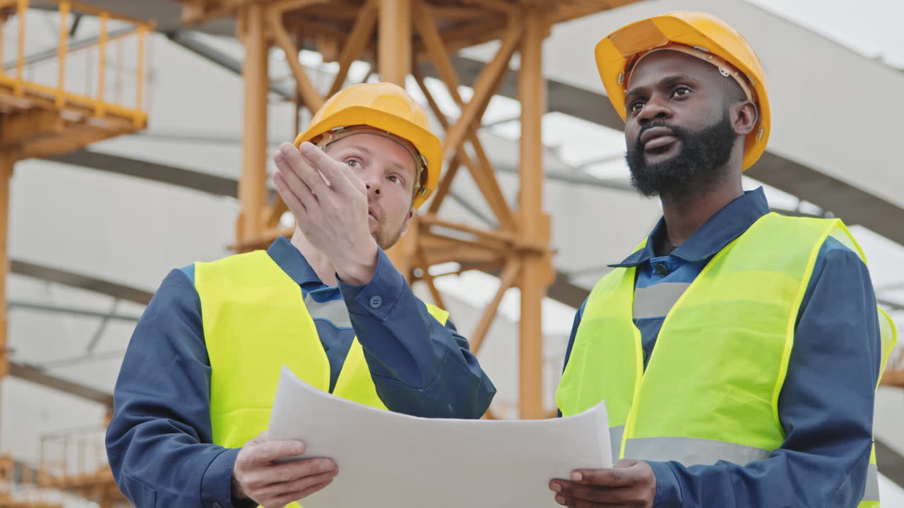 Construction Engineers Discussing Blueprint Outside