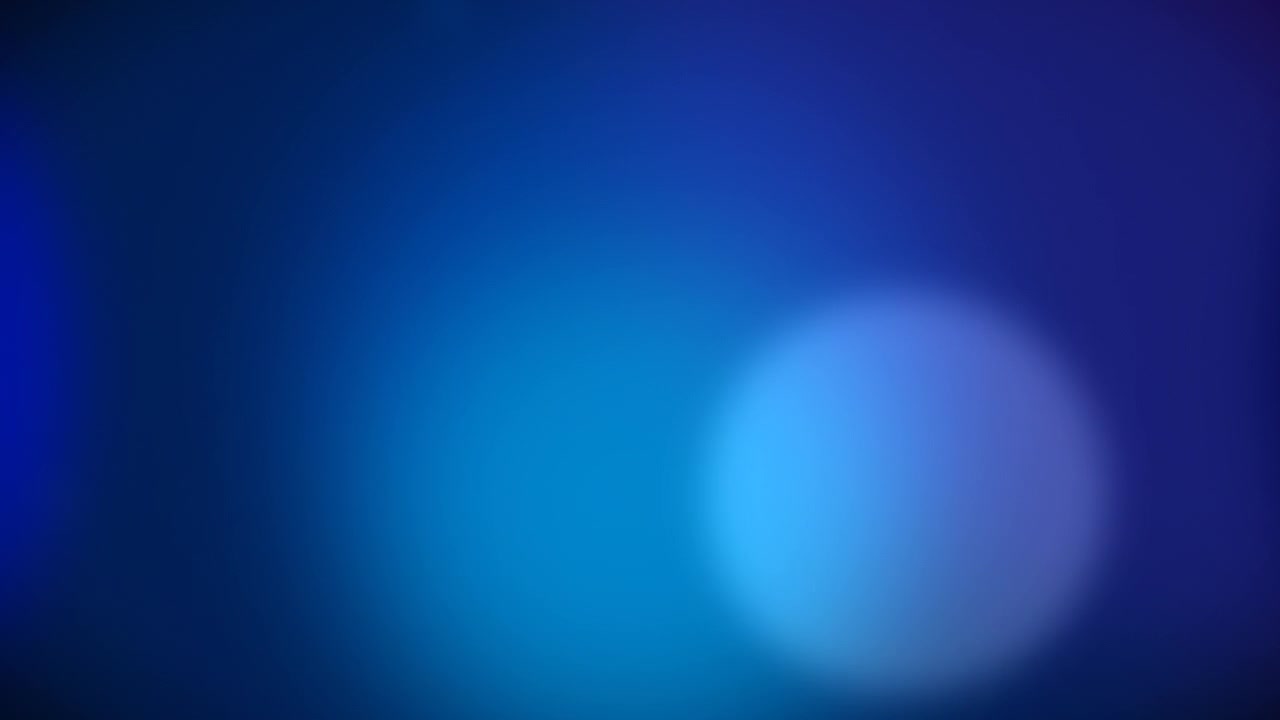 Abstract Blue Light Bokeh Moving Across Dark Background