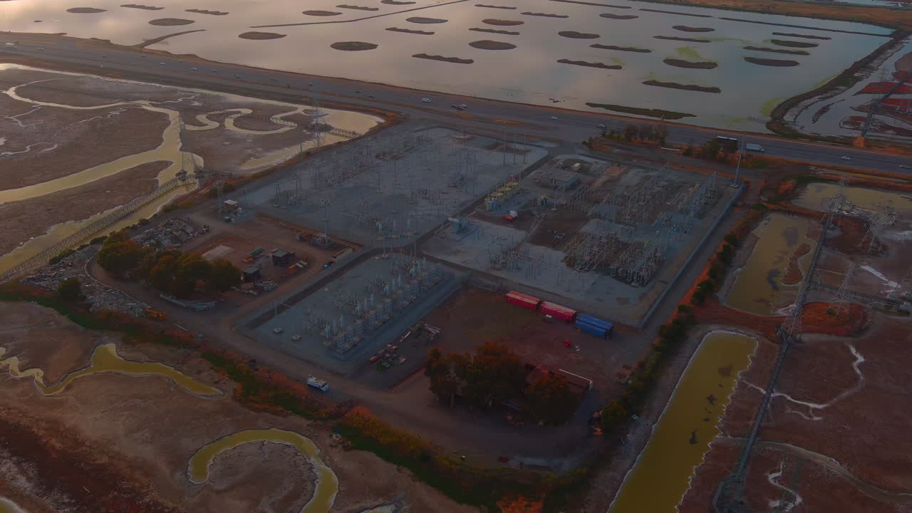 Power Distribution Center And Surrounding Wetland Areas Near Dumbarton Bridge Across San Francisco Bay In California, USA. Aerial Drone Shot