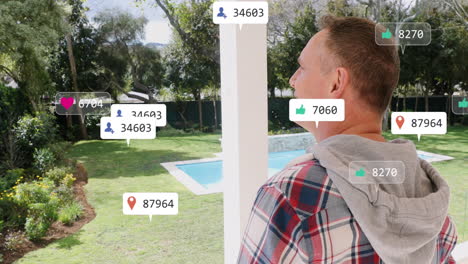 animation of social media icons over caucasian man stretching his arms on the porch of the house